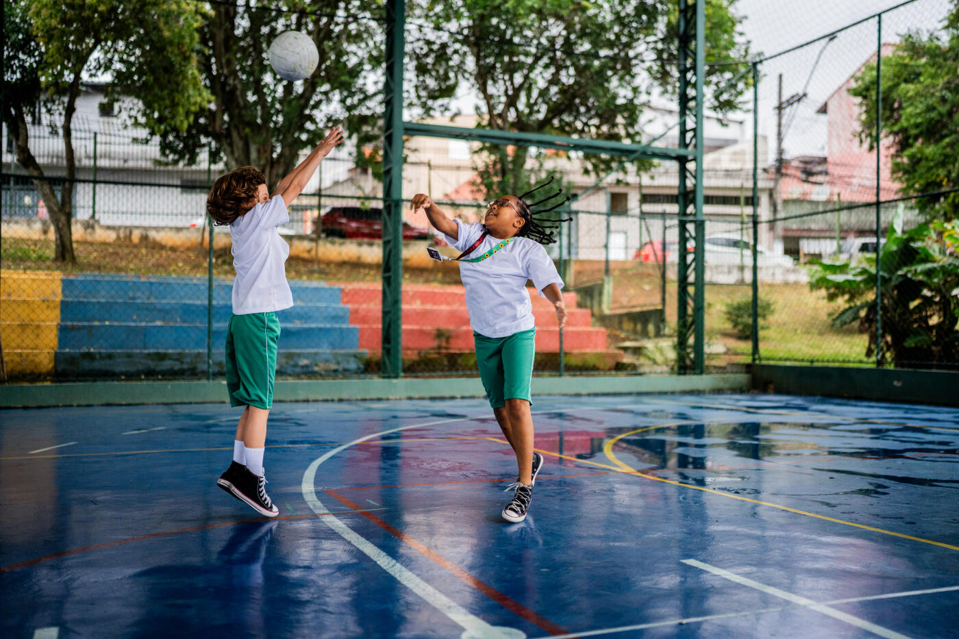 Children playing dobgeball during physical education class on sports court in the school