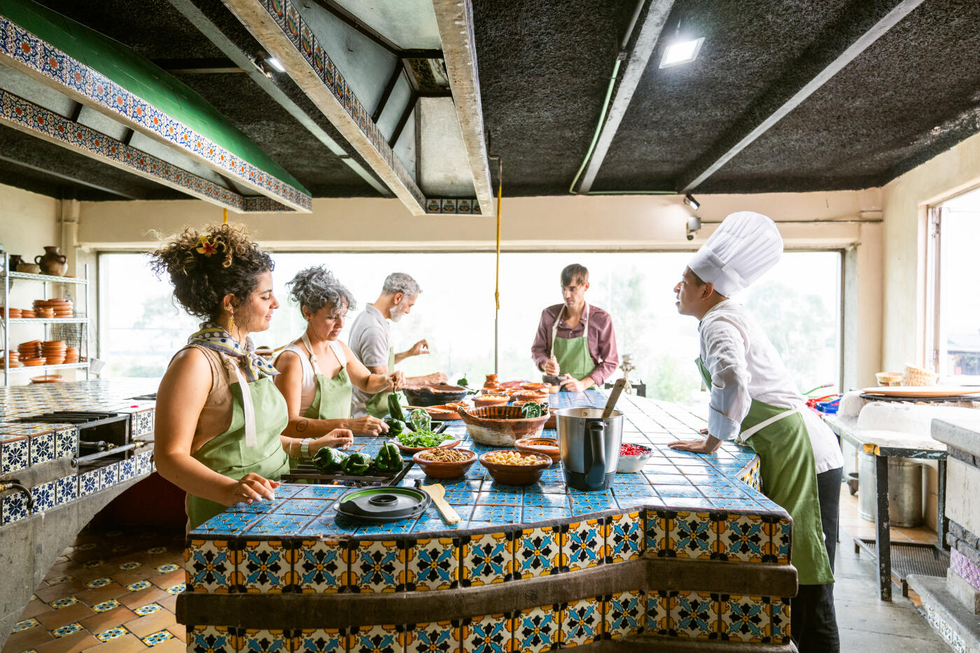 Chef shows tourists how to cook Chiles en Nogada a traditional Mexican dish