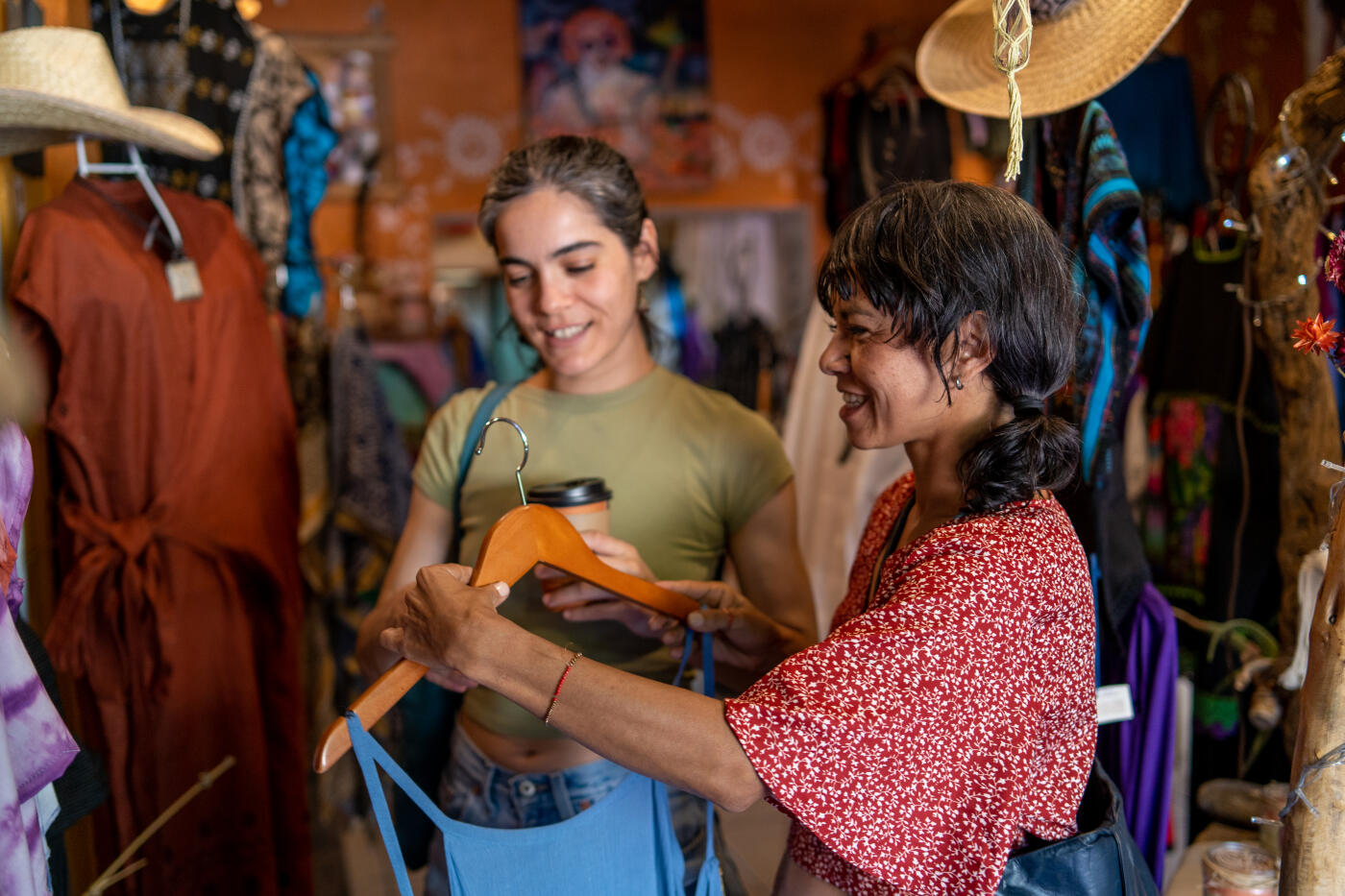 two female friends looking at products at a clothing and accesories store