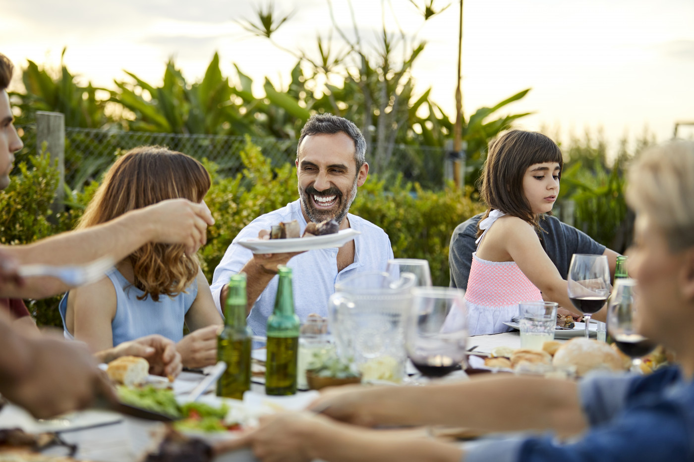 Males and females celebrating Asado in backyard