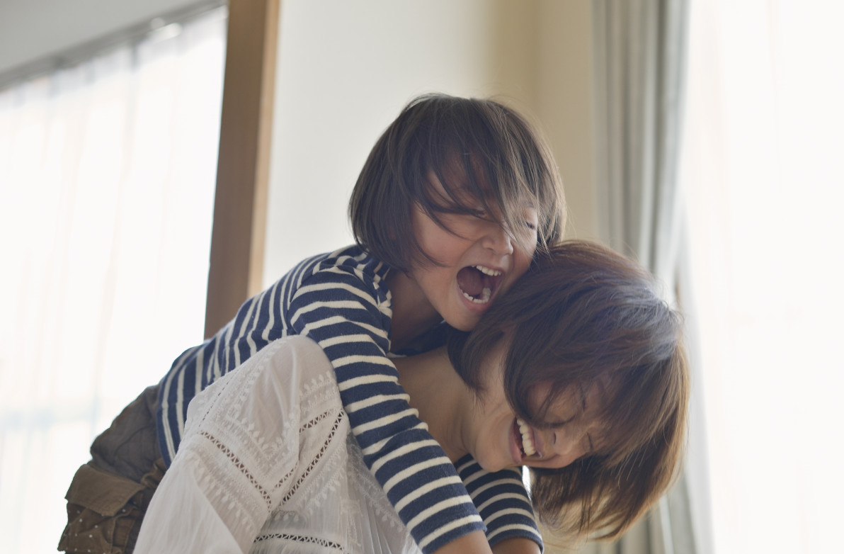 Mother giving daughter a piggyback ride,Girl of five years,Japan