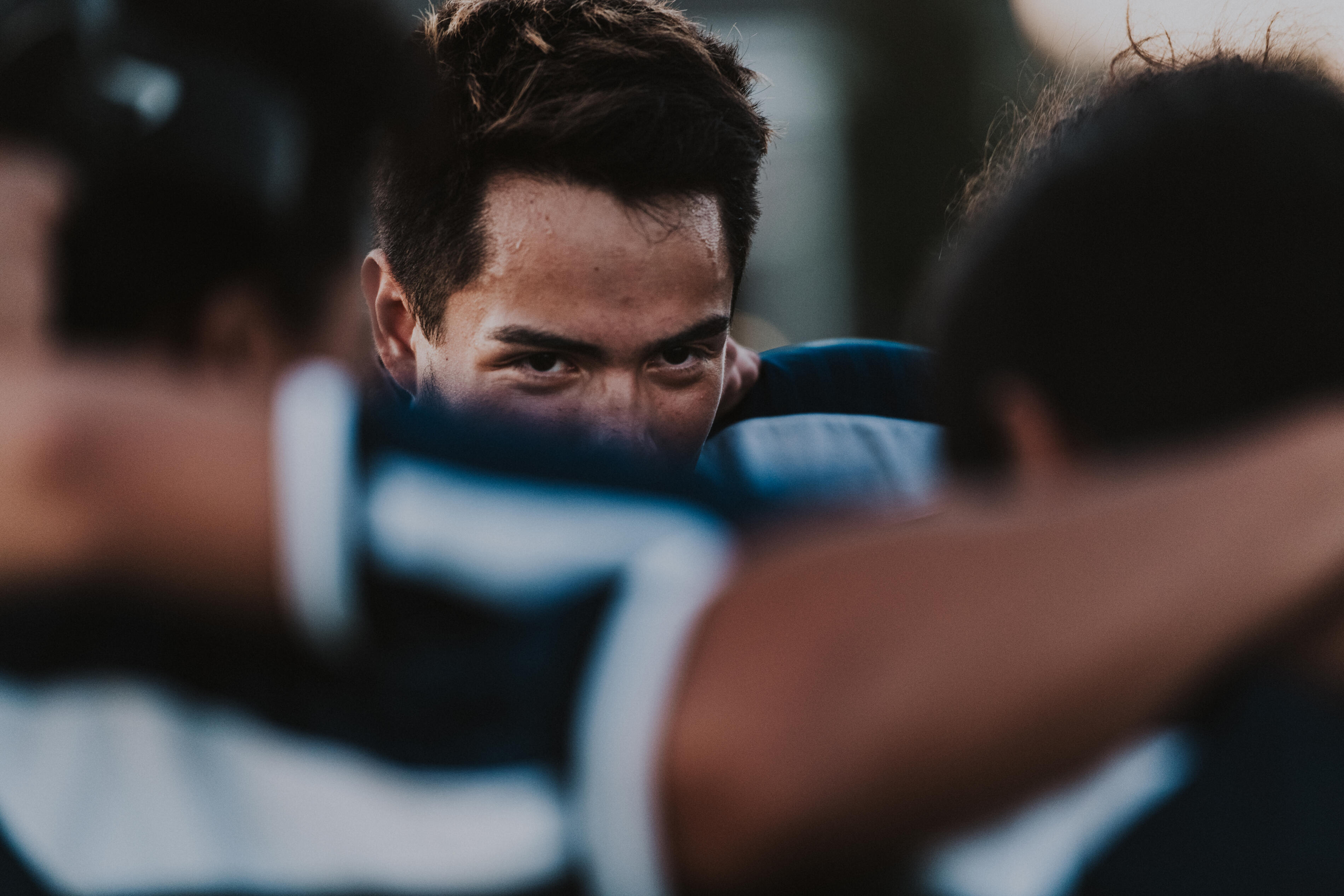 Young adult man in a soccer team huddle