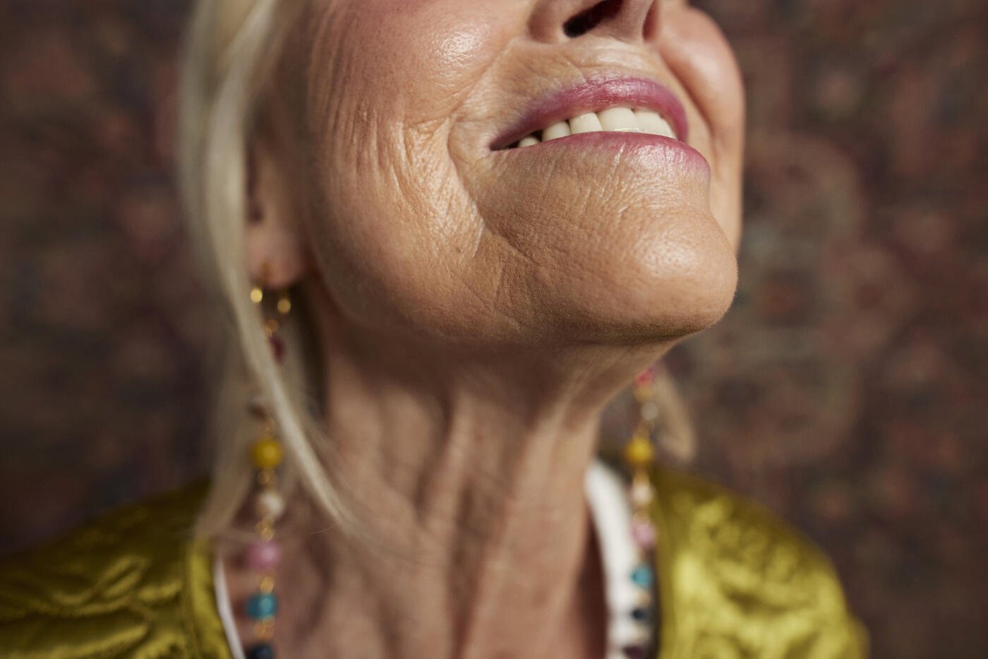 Close-up of midsection of smiling senior woman