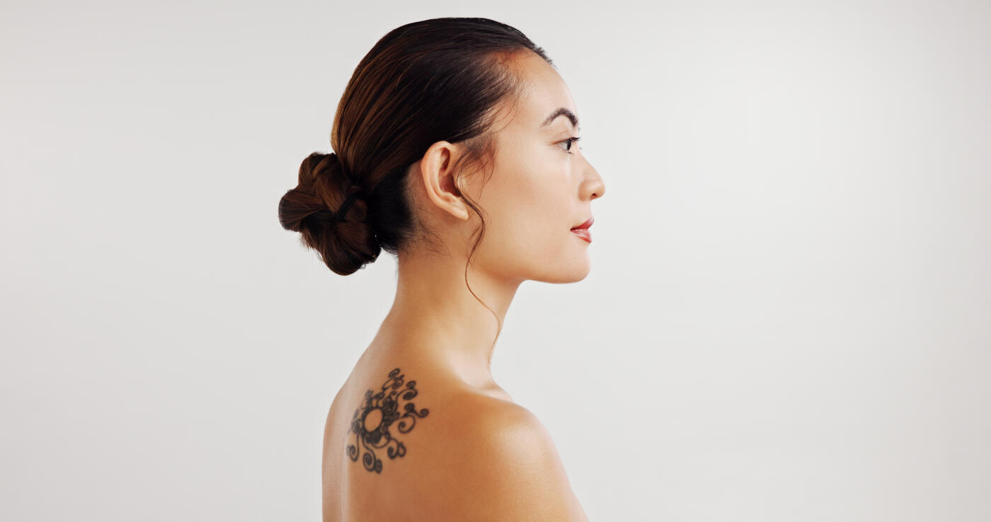 Thinking, woman and beauty for skincare in studio of flower tattoo, dermatology glow and natural treatment. Girl, relax and profile of organic cosmetics, aesthetic change and glow on white background