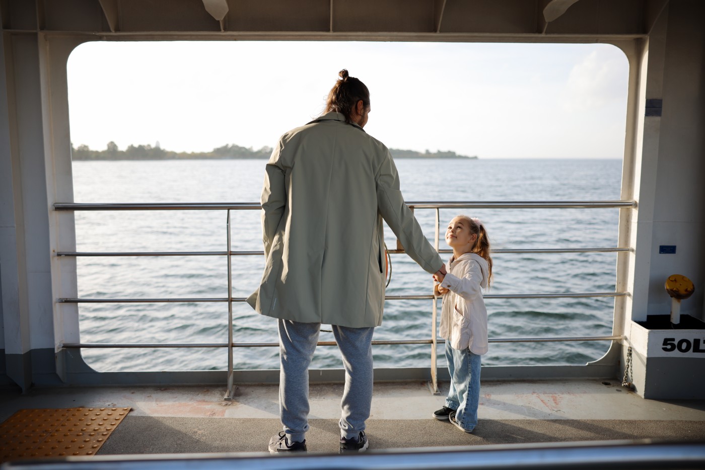 Daughter and Father Enjoy on the Ferry Boat Deck in Sunny Day Traveling on Vacation