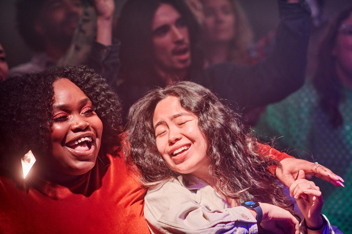 Young people having fun. Close-up of two women in the foreground.