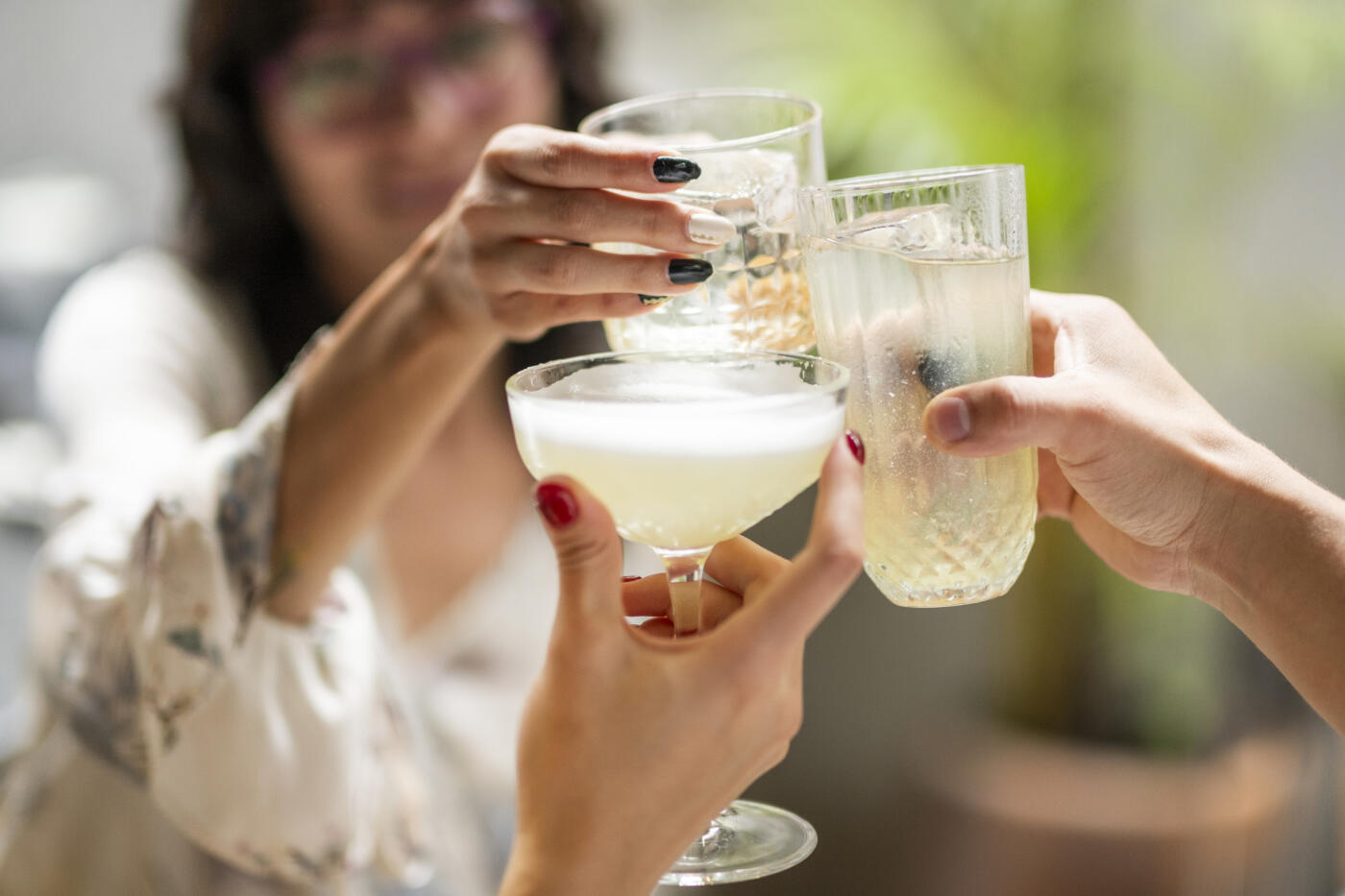 A group of young professionals having a meeting among colleagues and enjoying a few drinks.