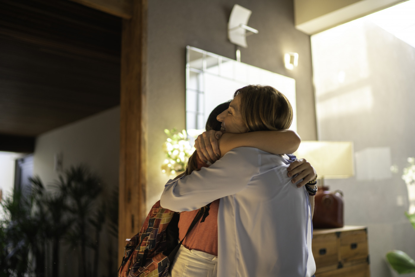 Teenager gilr and mature woman embracing