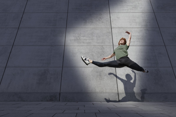 Male ballet dancer doing splits while jumping