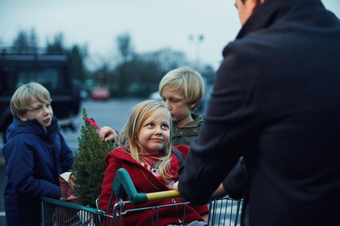 Father and three children Christmas food shopping together