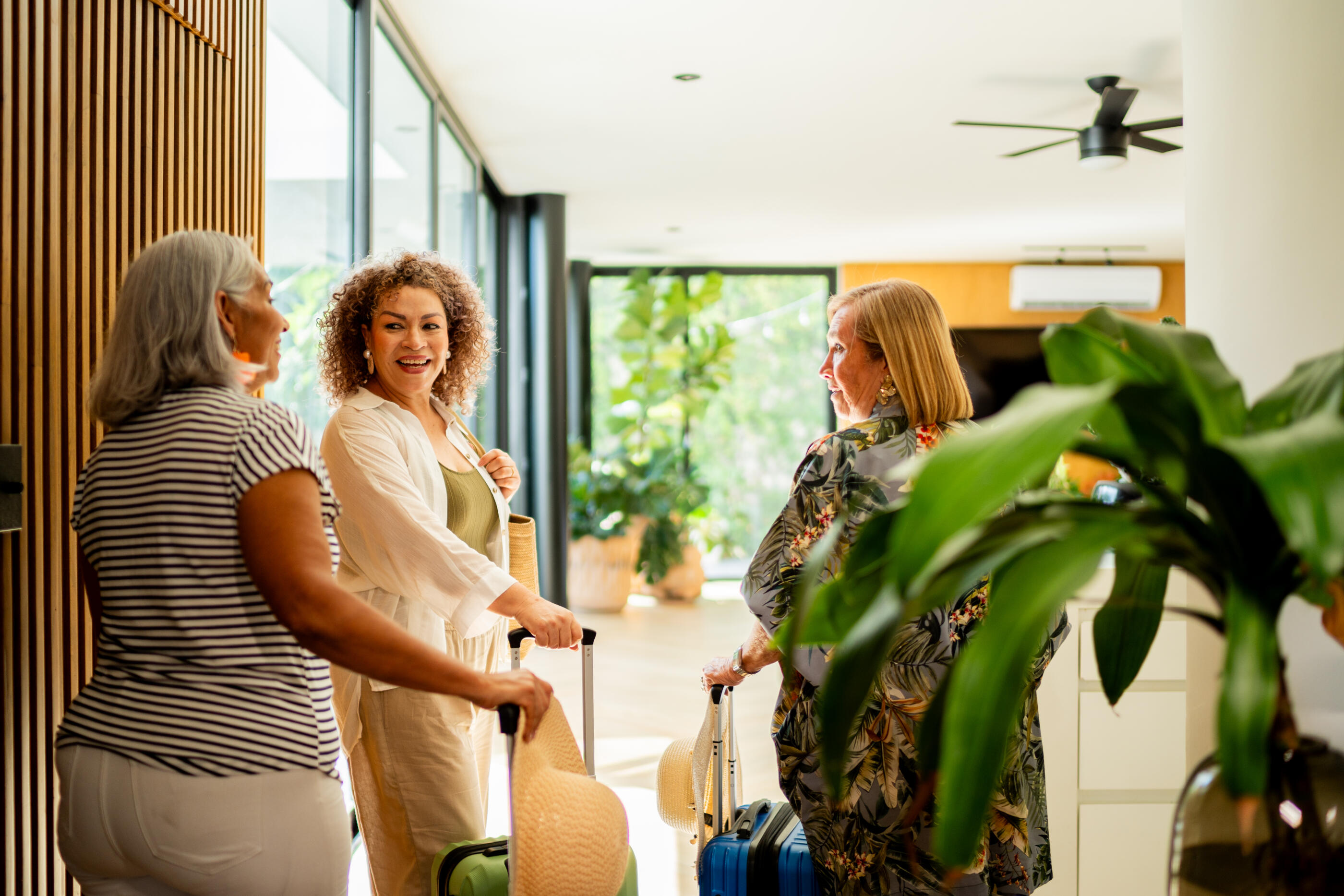 Senior friends women arriving on vacation rental