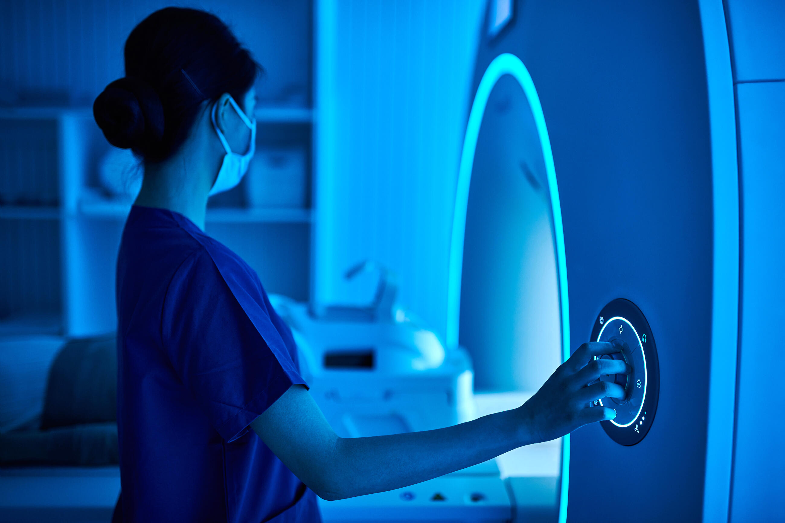 Female Nurse Operating MRI Scan Machine at MRI-scanner Room