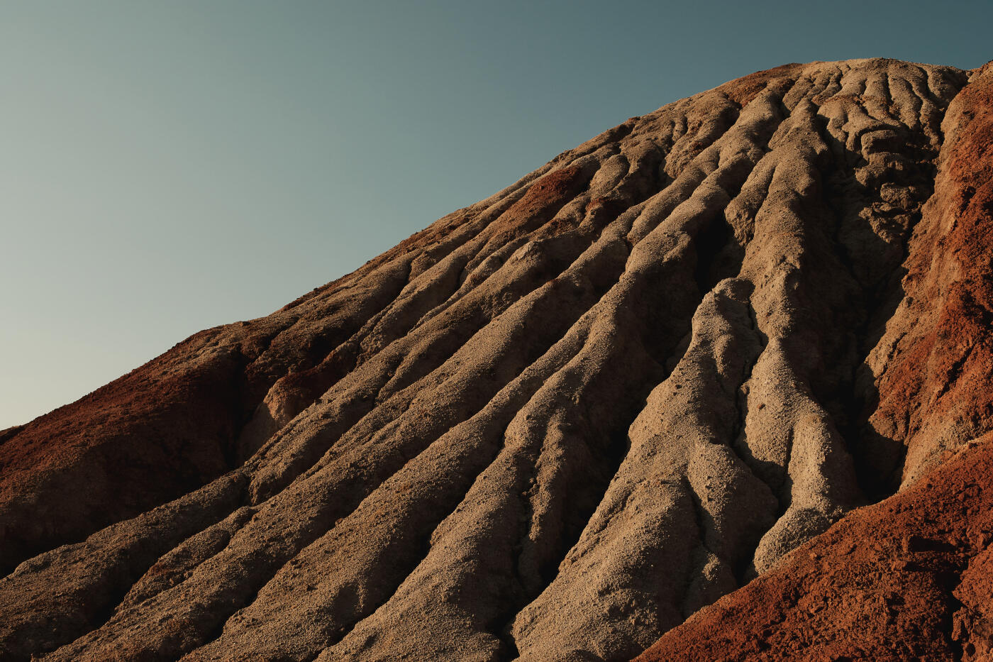 Ural Apocalyptic Surreal unusual landscape, similar to the surface of the planet Mars. Frozen red-brown surface of Chernozem. Barren, cracked and scorched earth and soil. The concept of global warming. Refractory clay quarries. Textured background.