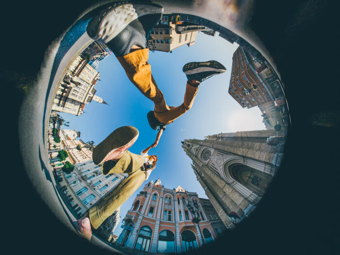 Happy traveler couple enjoying a famous place. Little Planet format.