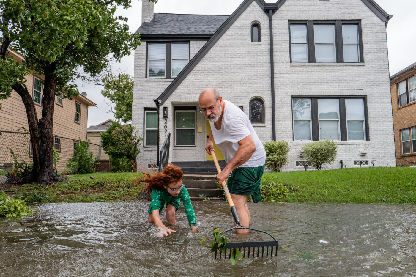 HOUSTON, TEXAS - JULY 08: Jack Reyna and his son work to drain floodwater in their neighborhood after Hurricane Beryl swept through the area on July 08, 2024 in Houston, Texas. Tropical Storm Beryl developed into a Category 1 hurricane as it hit the Texas coast late last night. (Photo by Brandon Bell/Getty Images)