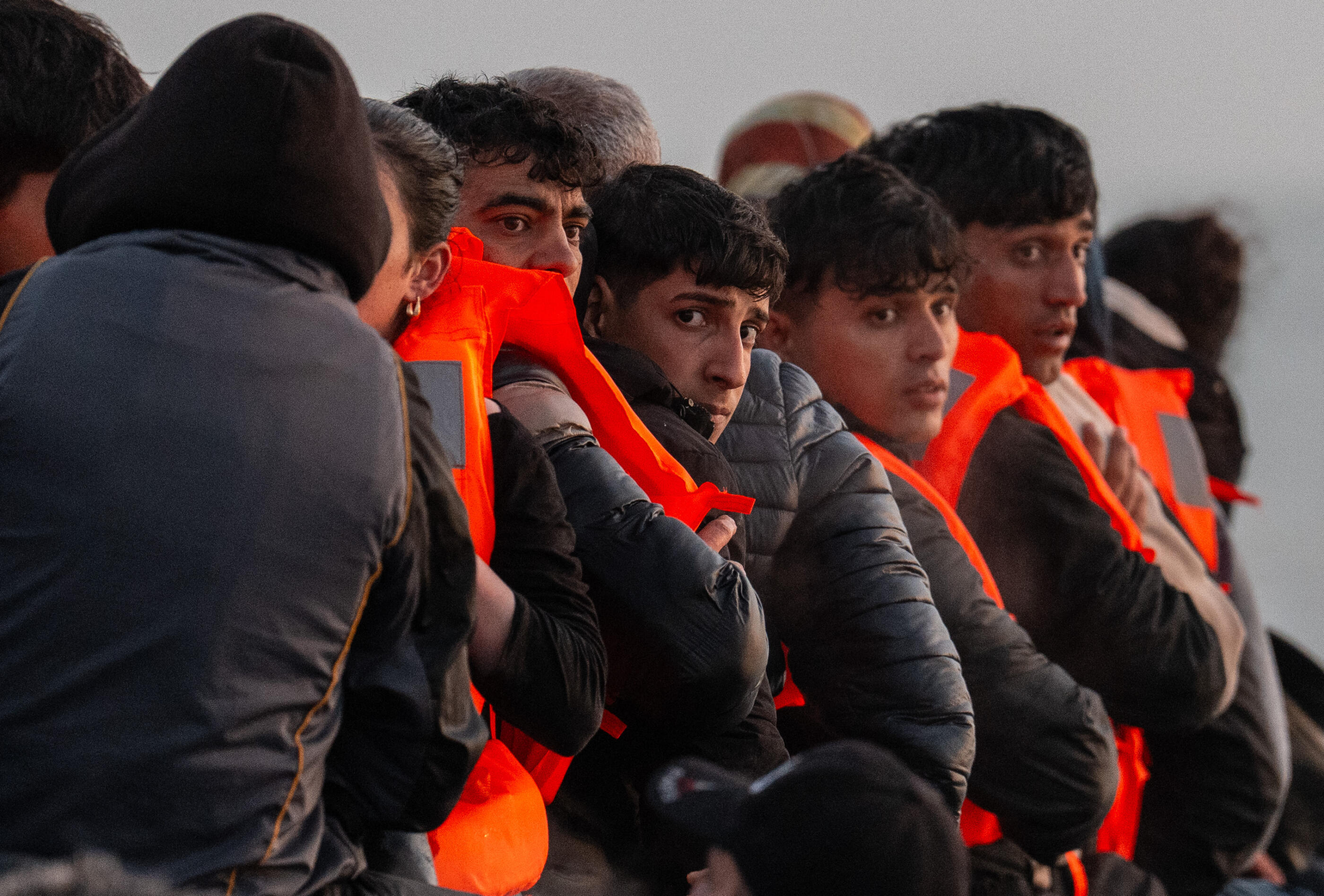 GRAVELINES, FRANCE - MAY 31: Migrants sit on a dinghy as they wait to sail into the English Channel on May 31, 2025 in Gravelines, France. The numbers of migrants crossing the English Channel in small boats is up roughly 40% on last year. It was reported in April that the UK and France are holding negotiations over a potential deal to return irregular migrants who cross the English Channel in small boats. The pilot scheme would see the UK send a limited number of people who have crossed illegally sent back to France, in exchange for accepting some people who have a case for family reunification and right to be in the UK. (Photo by Carl Court/Getty Images)