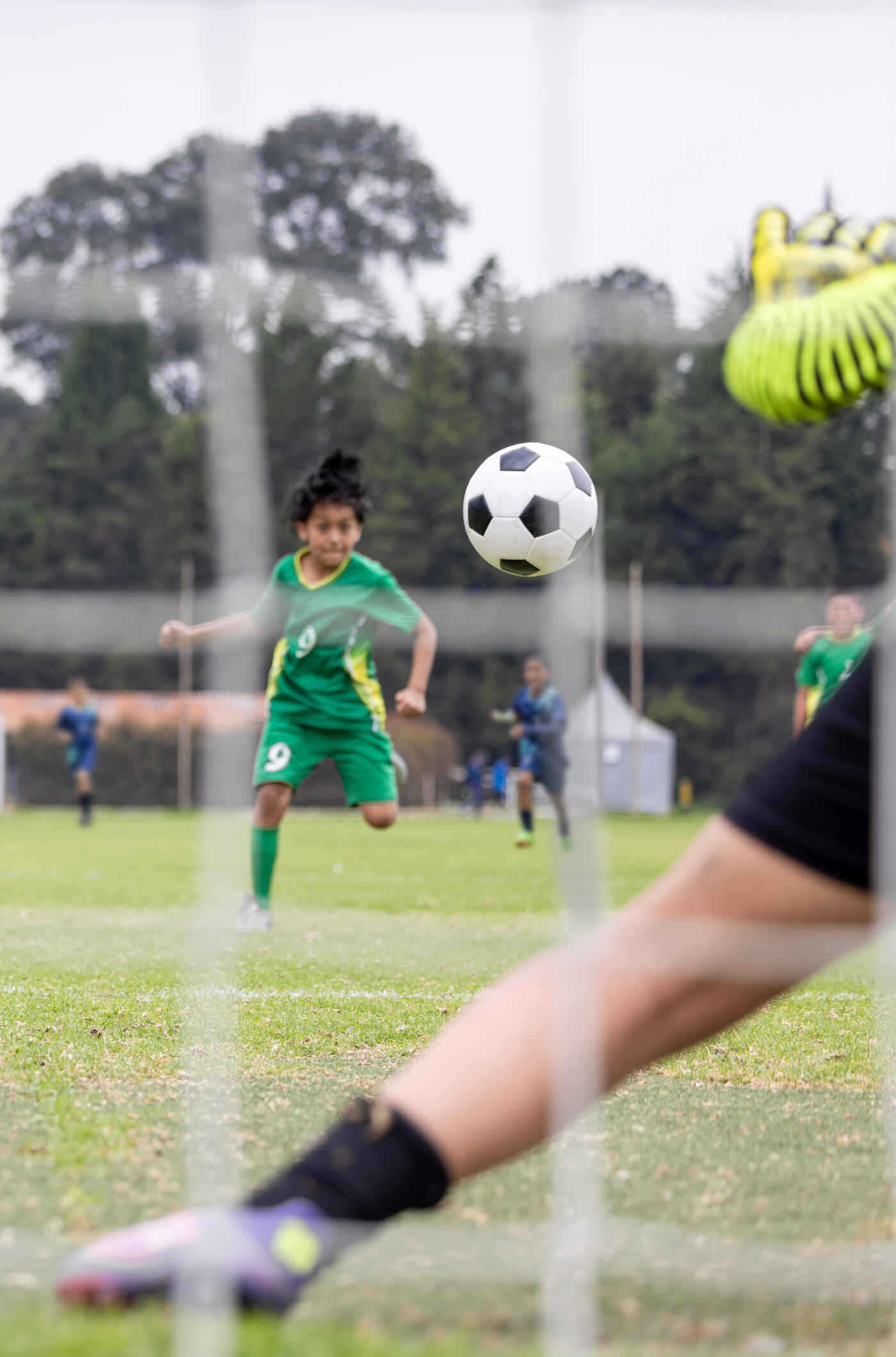 Young Latin American soccer player in the air heading a ball during a game - sports concept