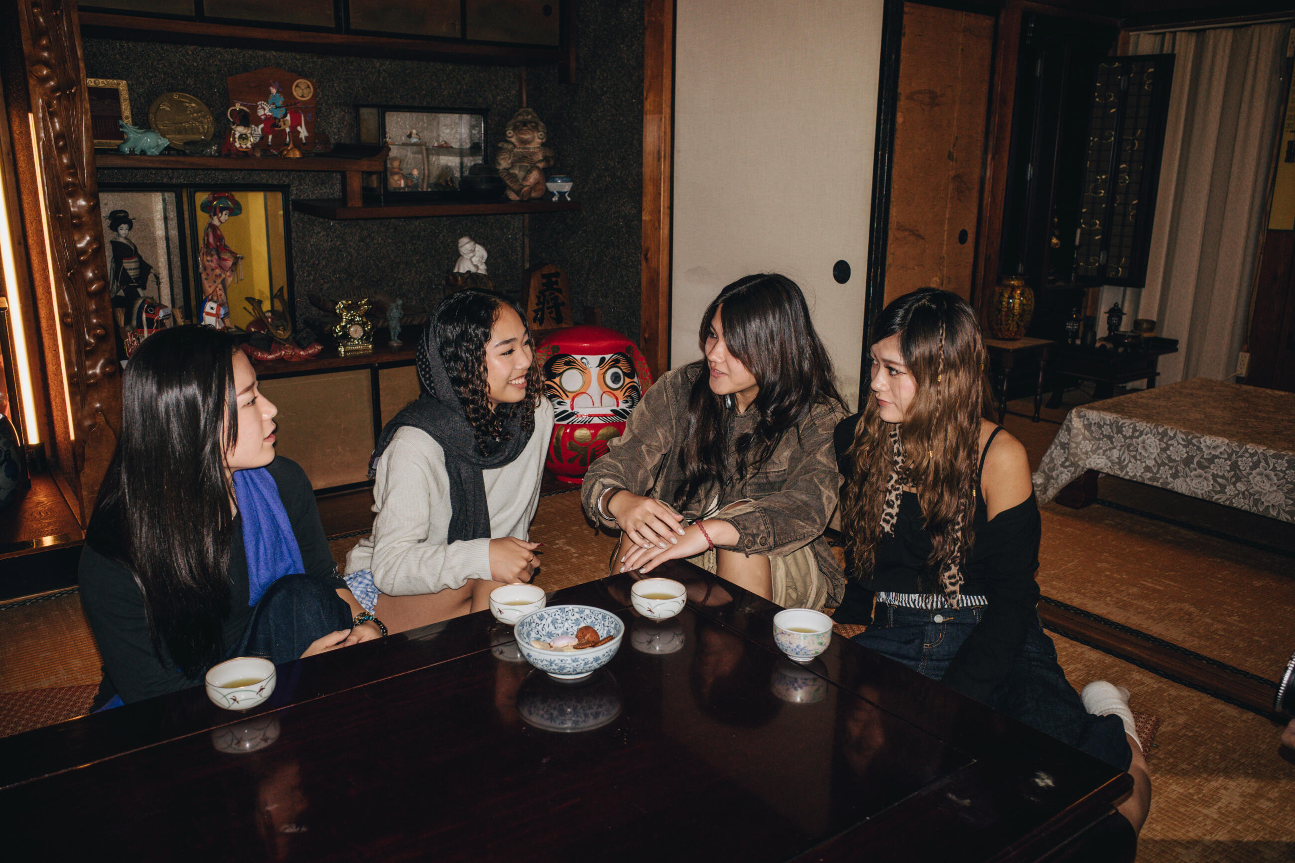 A group of female students from various colleges gathered for a meal and socialize at an old house in Tokyo, Japan.