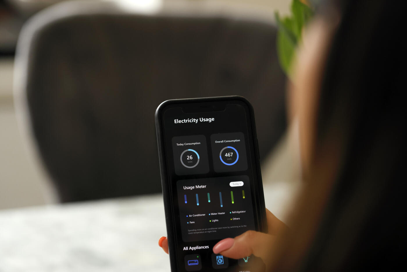 Close up of a women adjusting her electricity usage from her smart phone