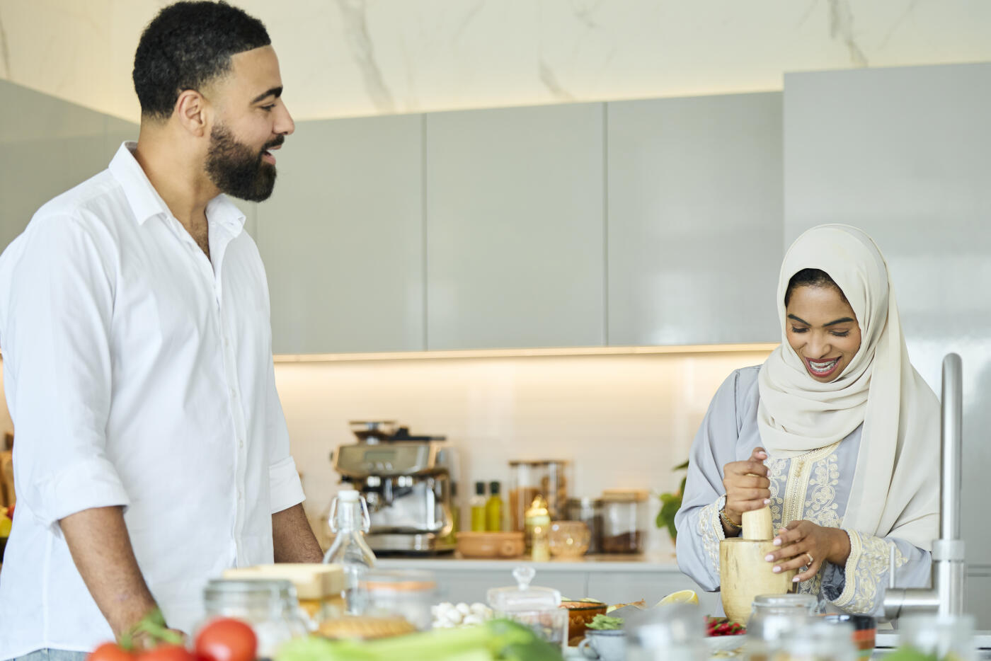 Couple preparing food in modern kitchen at home