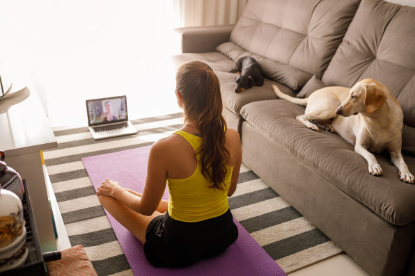Woman practicing yoga in video conference