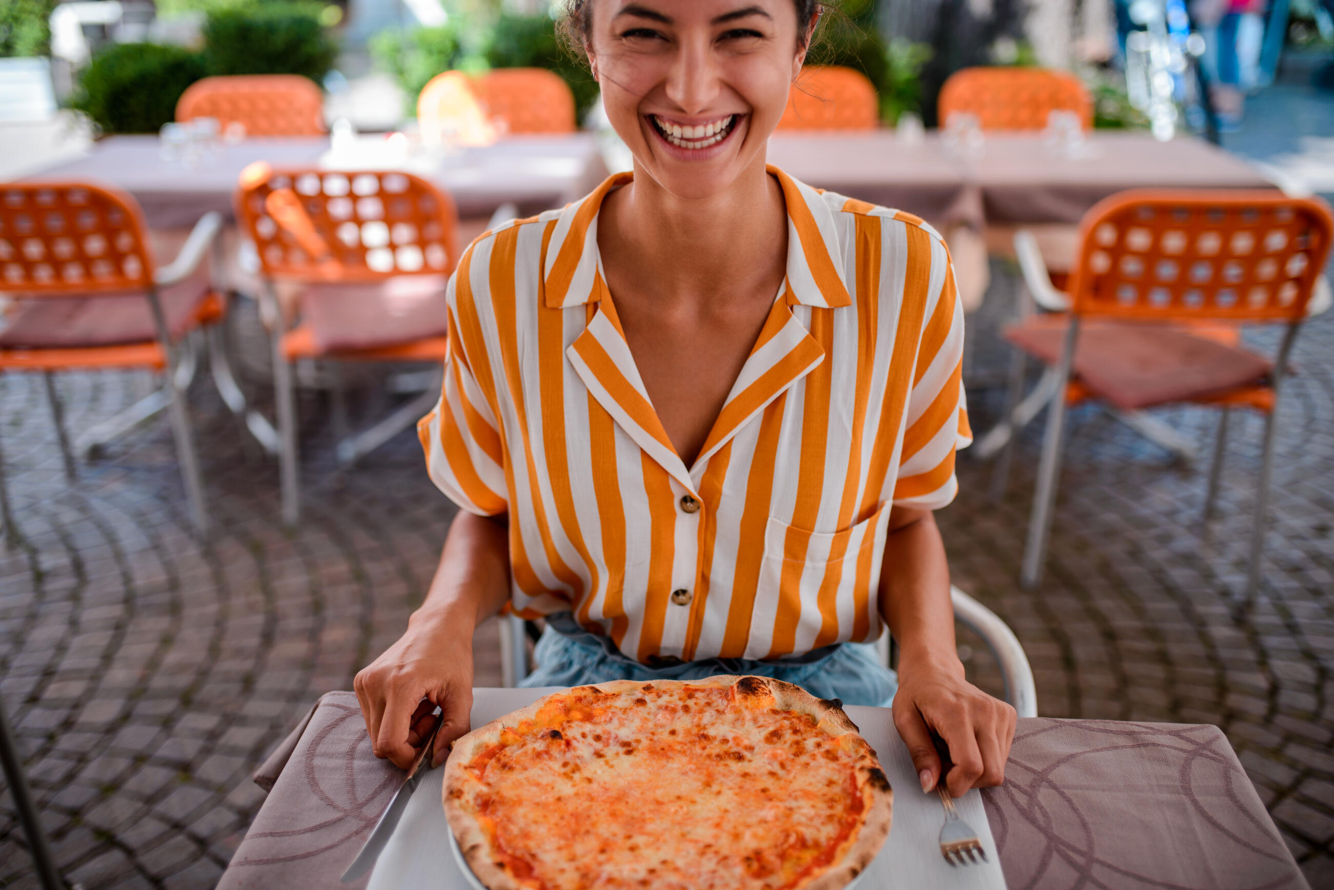 Happy woman eating pizza.