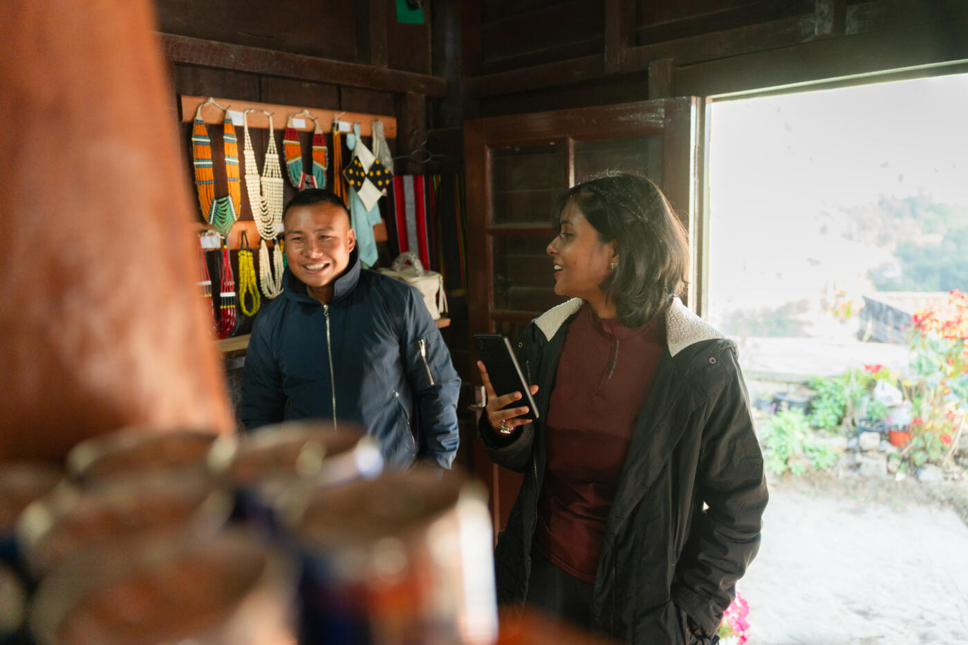 Young Woman Exploring Local Artifacts in a store at Khonoma,Nagaland.