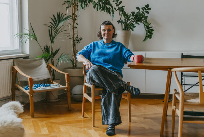 Portrait of smiling mature woman sitting with coffee cup at dining table