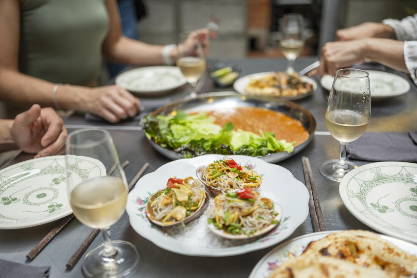A group of young professionals enjoying a delicious meal with friends in a modern restaurant