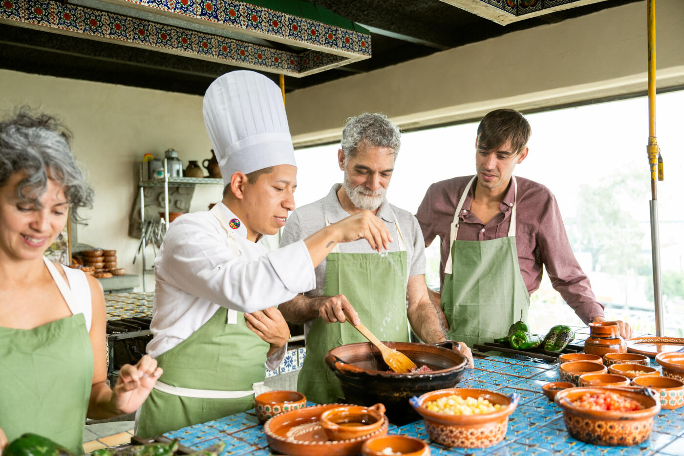 Chef shows tourists how to cook Chiles en Nogada a traditional Mexican dish