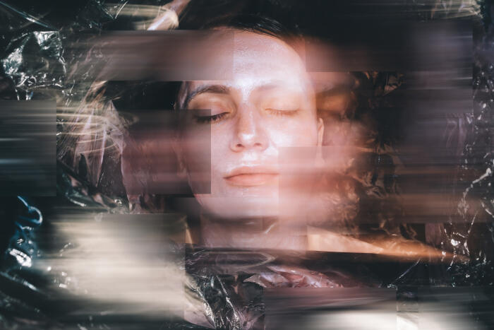 A woman with closed eyes appears beneath fragmented, horizontal digital distortions and translucent textures.