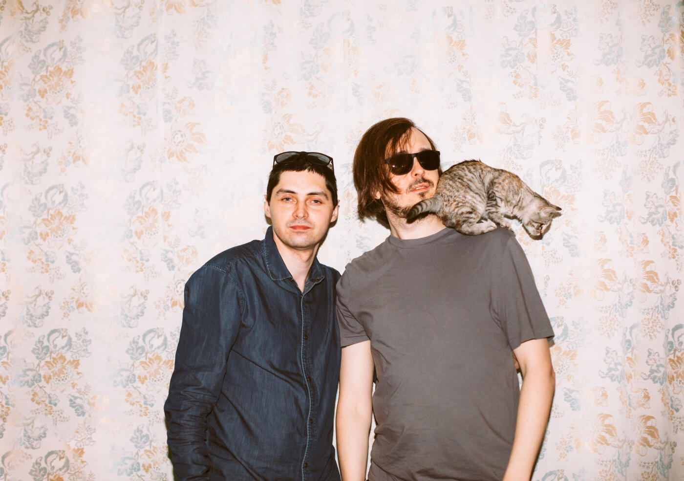 Portrait of friends with cat at home party