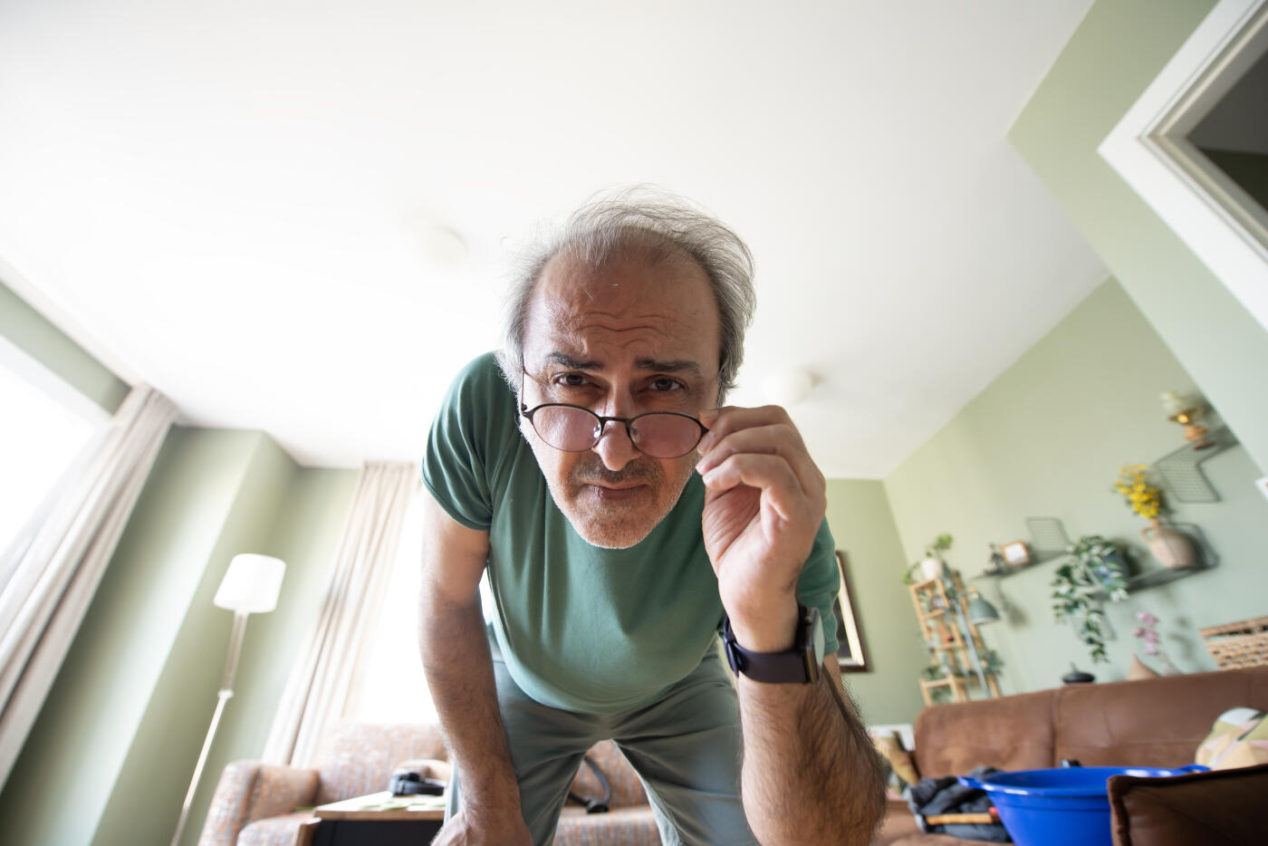 A Man Reaching to Adjust a Smart Digital Thermostat or Touch Screen Smart Home Device, from Unique POV of Device