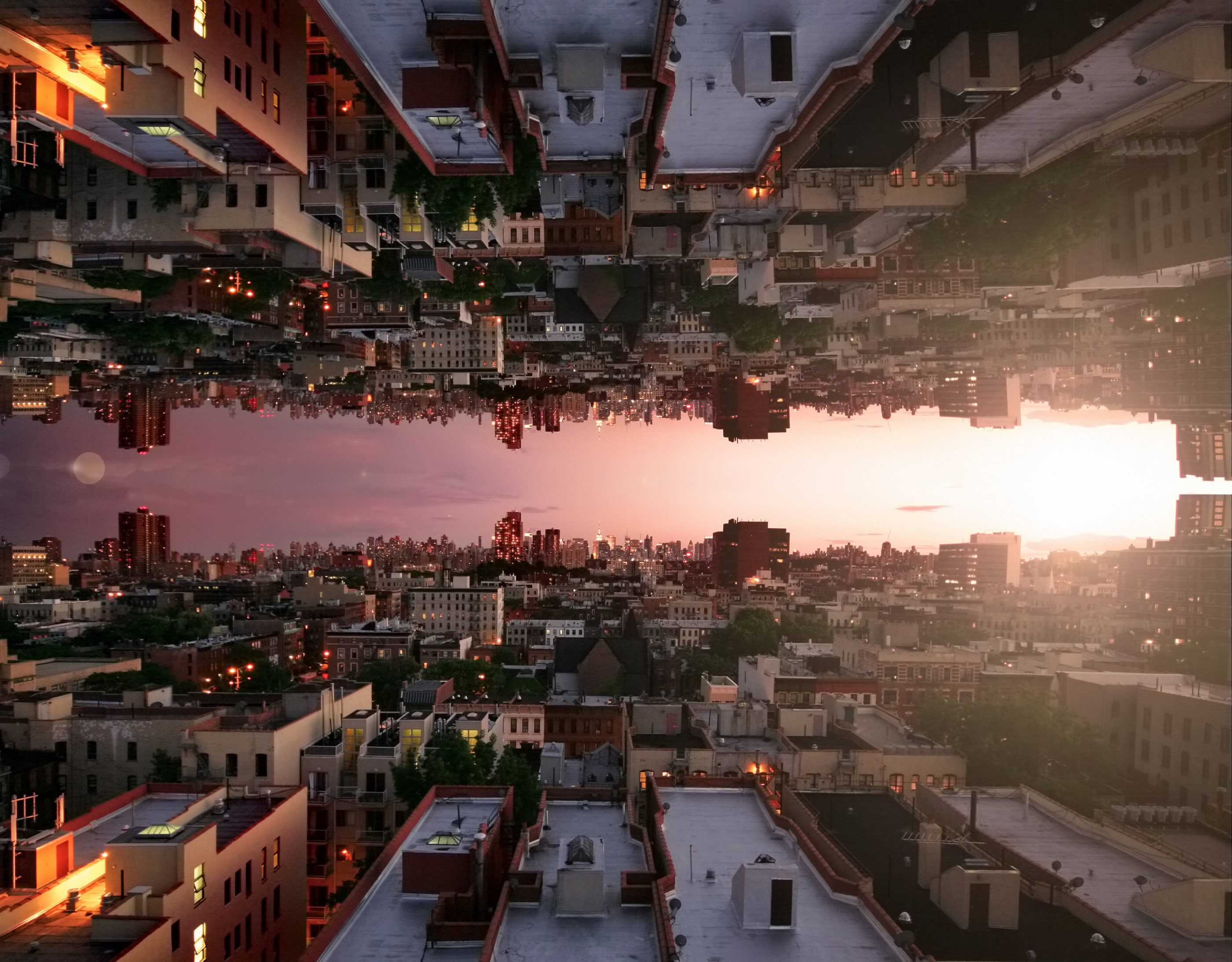 Capsized reflected image of horizon at sunset over rooftops in Harlem, New York City