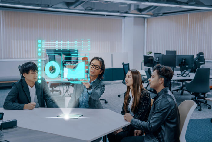 Business meeting using futuristic holographic interface in a corporate office.