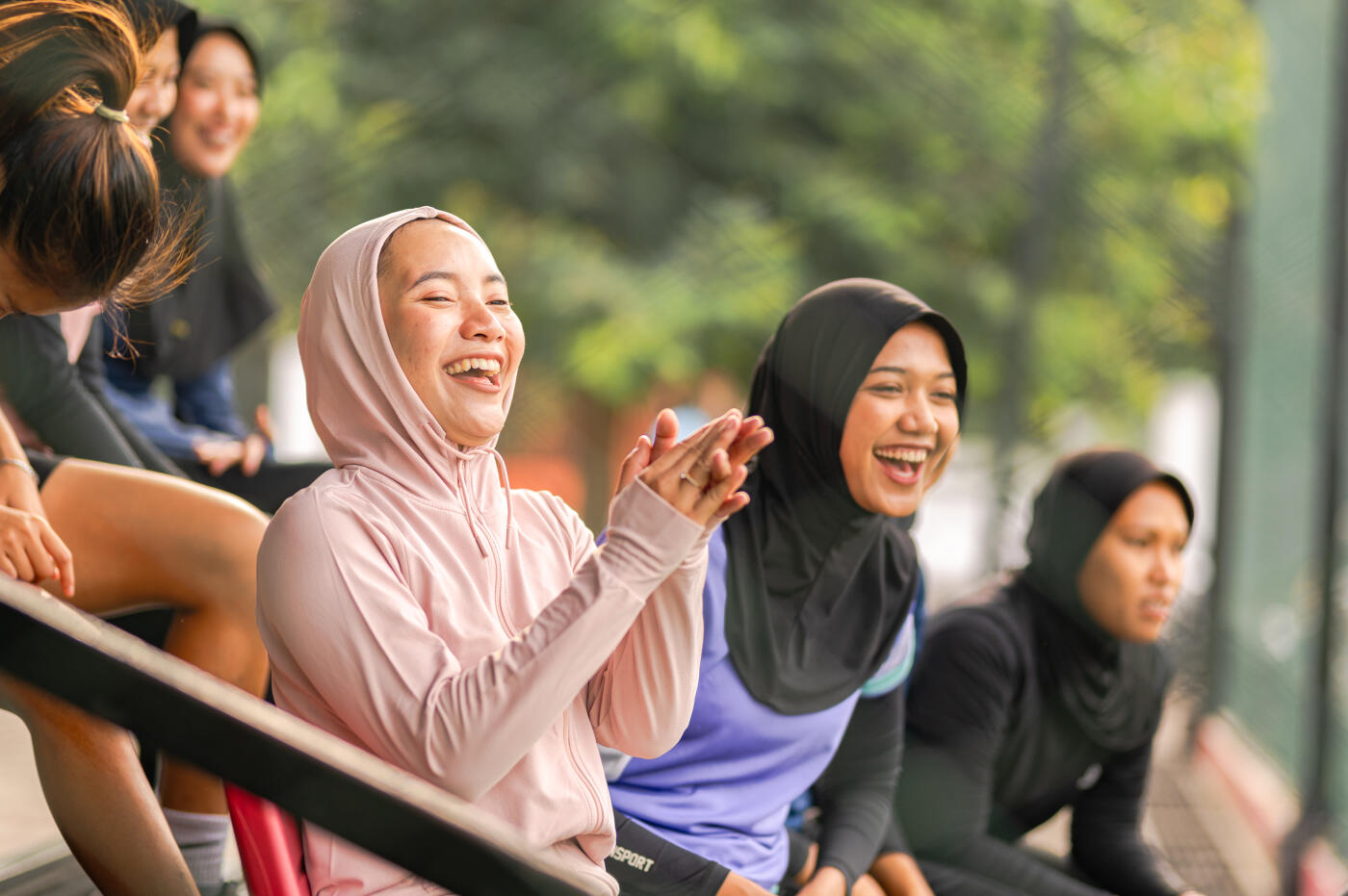 Young Asian women  watching the game at side of field and clap the hand