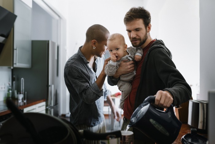 Gay father Multitasking with baby