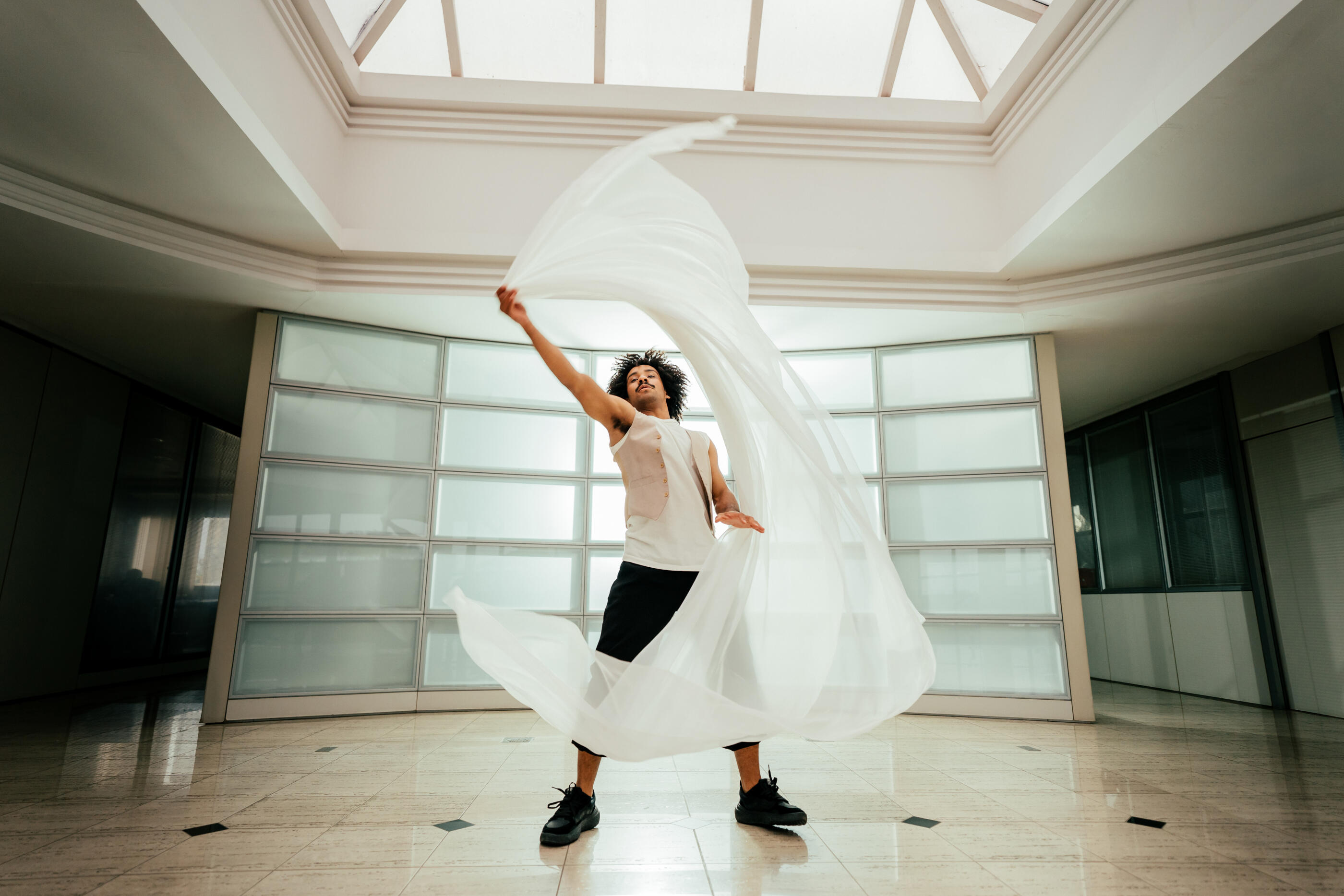 Conceptual image of a male dancer dancing with fabrics