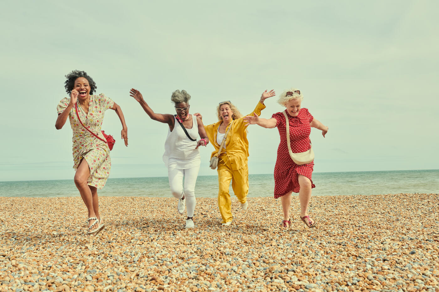 Four friends enjoying a day trip to the beach on a summers day.
