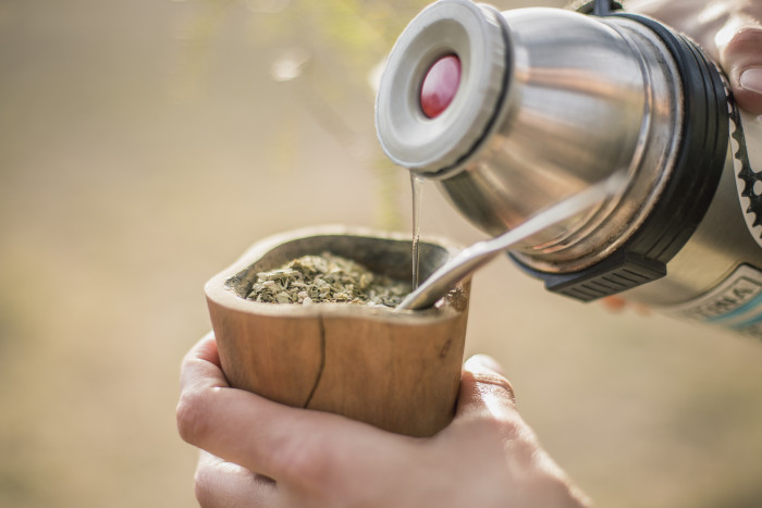 Cropped Hands Making Yerba Mate Tea In Wooden Cup