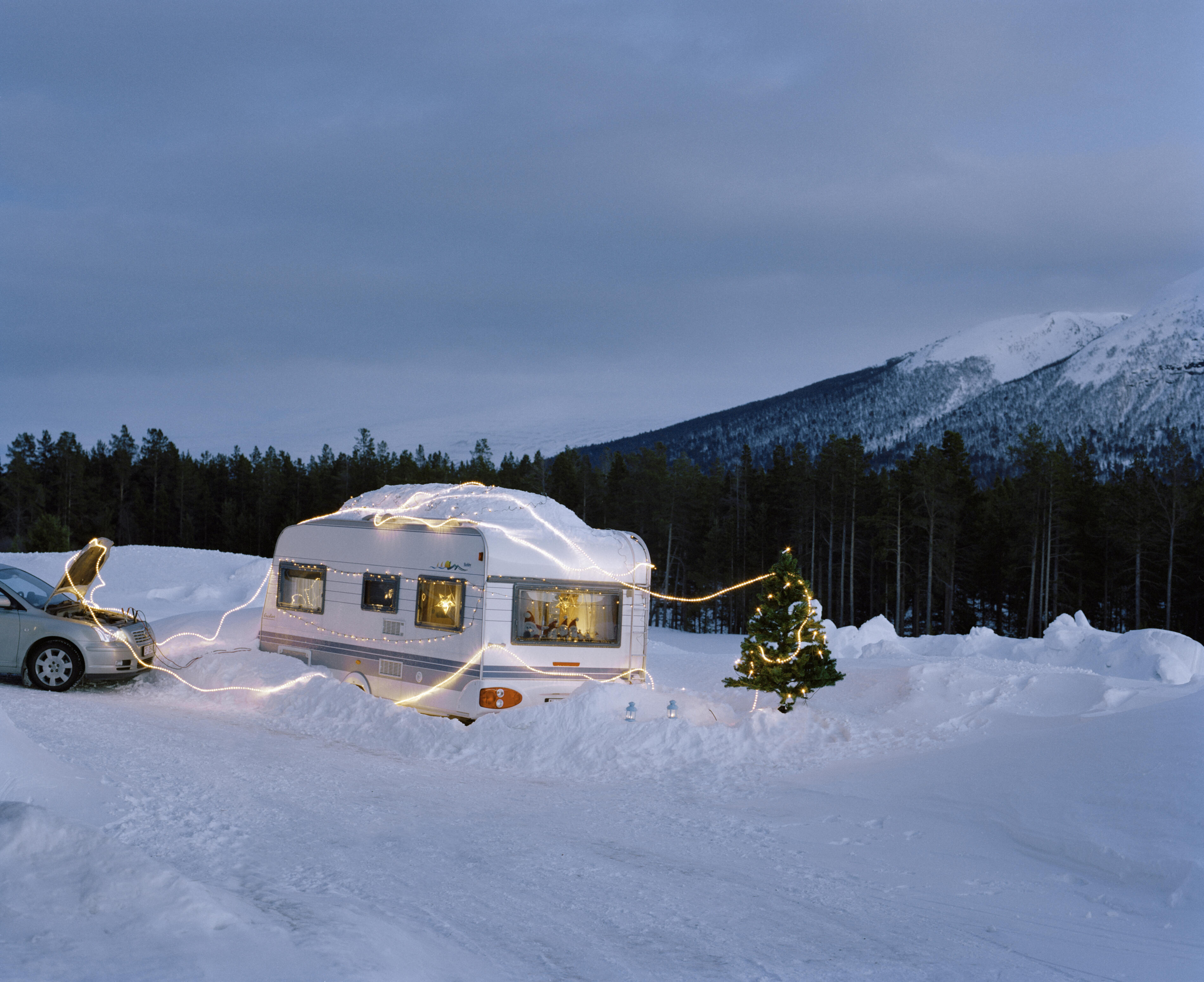 Car powering Christmas lights on caravan