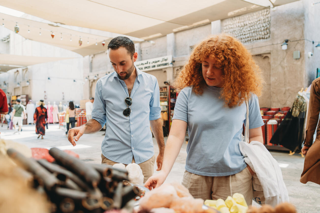 Tourists choosing spices at Dubai Spice Souk in Old Dubai