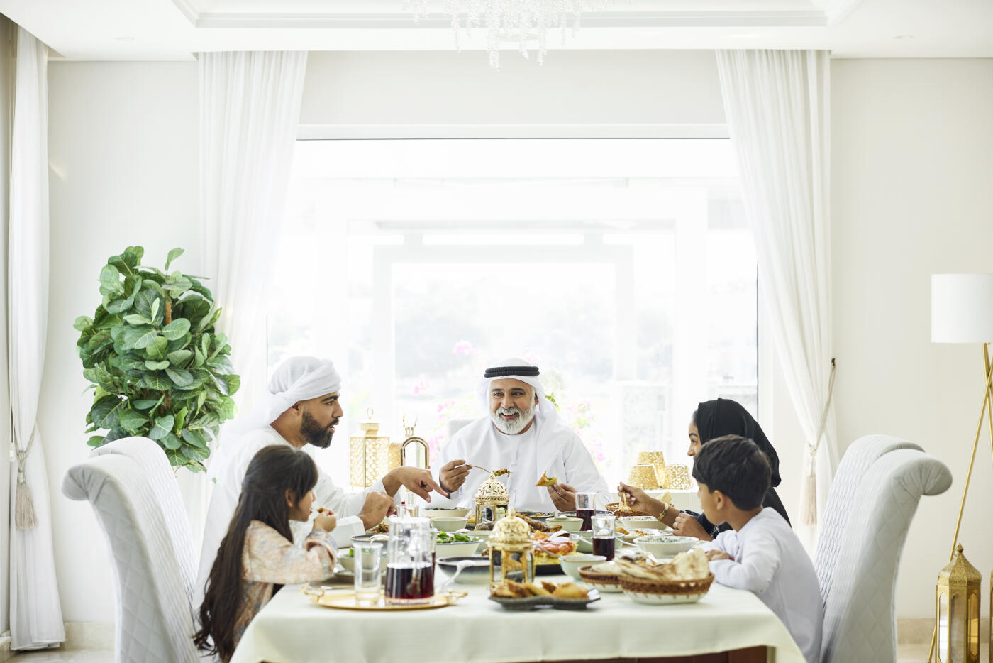 Happy middle eastern family having lunch at home