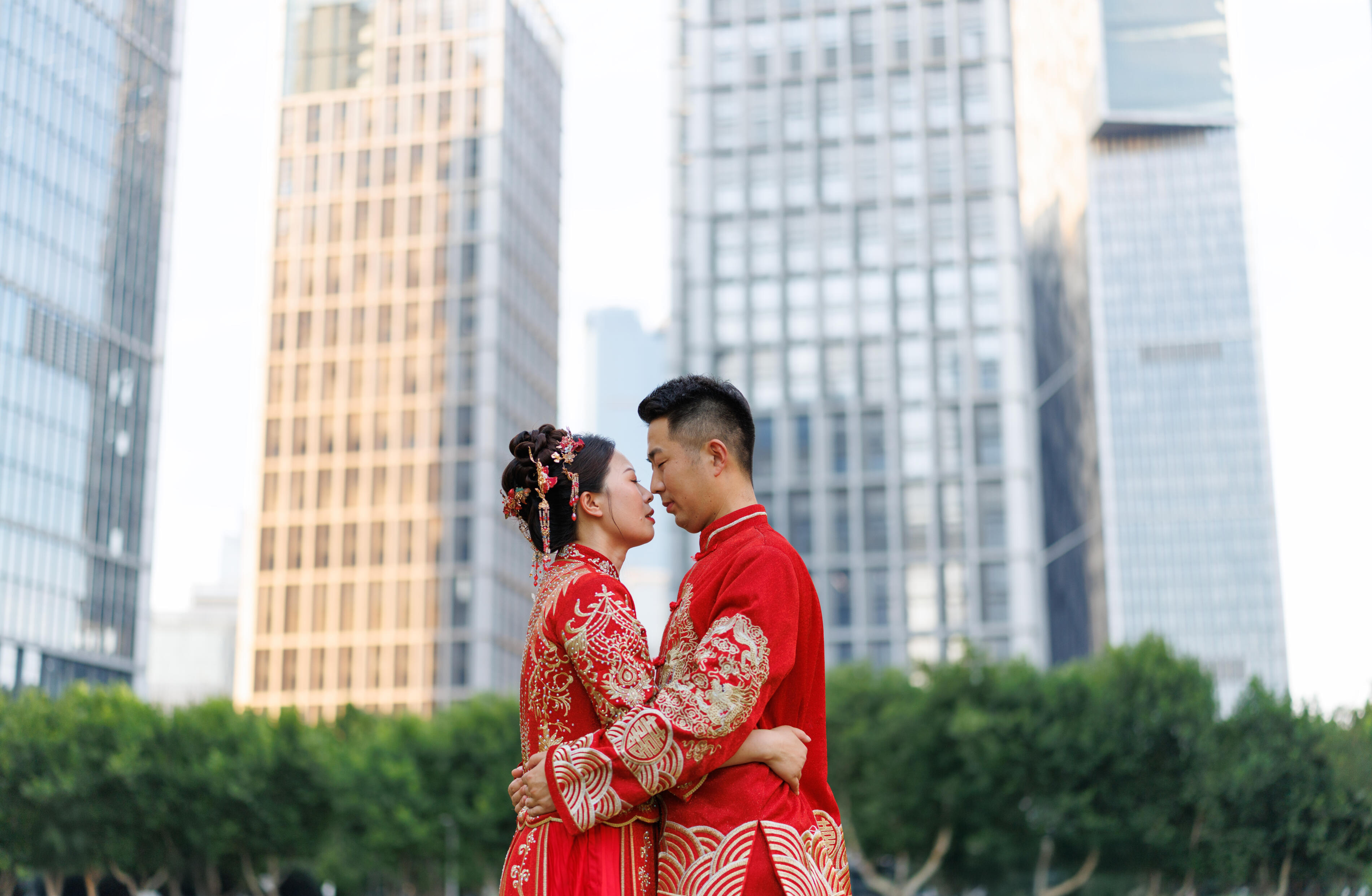 A Chinese newlywed couple in their 30s, wearing Hanfu costumes, hug each other in a modern city on their wedding day, traditional costumes and modern city concept