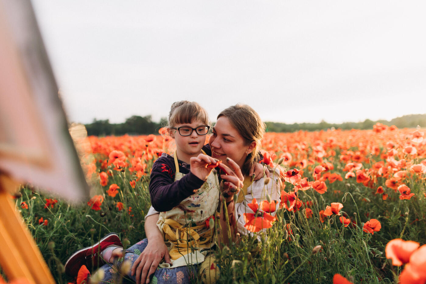 The art therapist's caring embrace fosters a sense of belonging and acceptance, allowing the girl to feel valued and understood. Through art, she discovers a powerful means of self-expression, finding her voice beyond words.