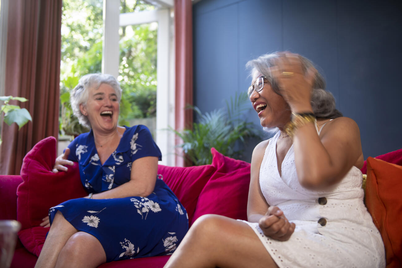 Two silver haired women laughing