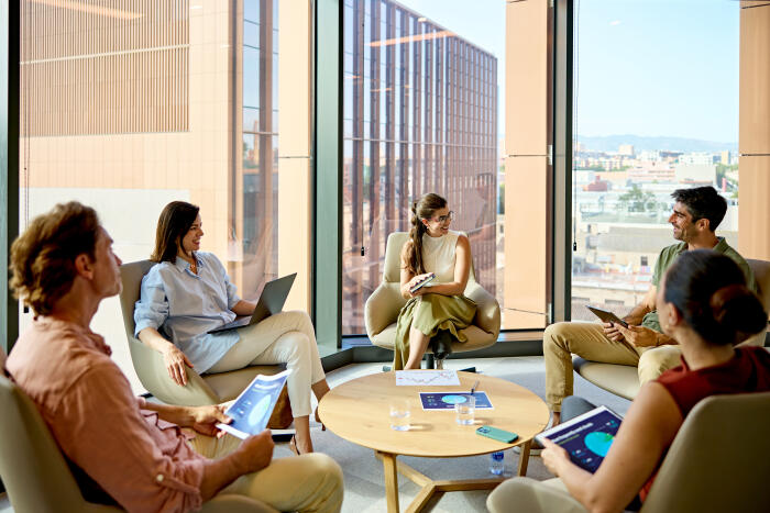 Diverse business team collaborating in modern office meeting