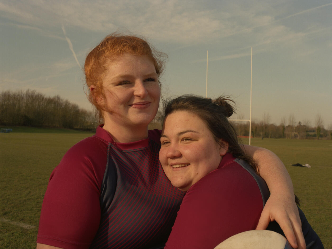 England, UK - February 17, 2019: Two team members hugging during a rugby training session