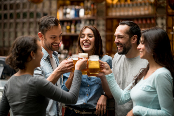 Happy group of friends making a toast at a restaurant