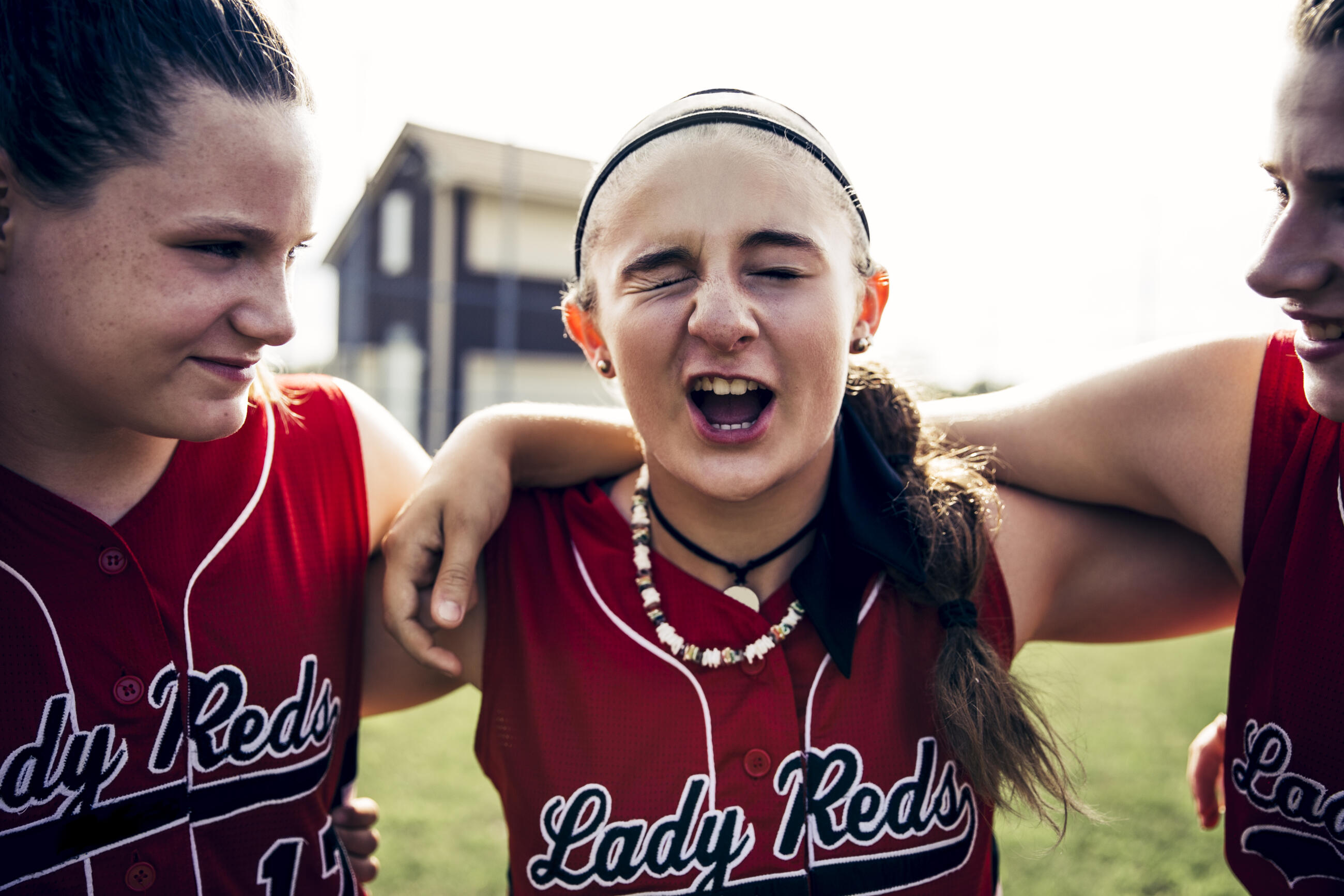Girl's softball team huddling on field before game